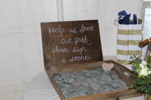 Boxed filled with stones for wedding guests to leave a message for the bride and groom